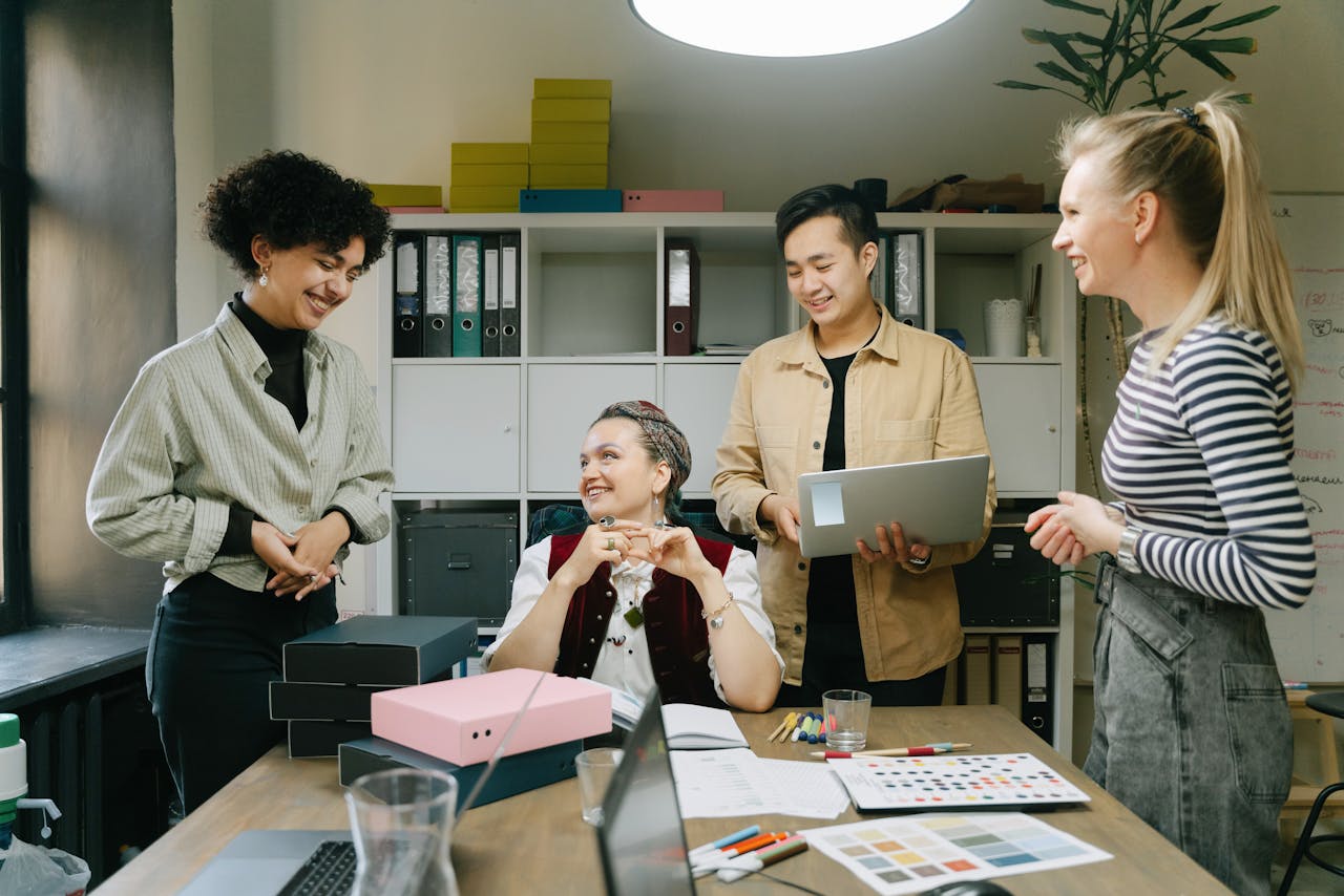 Colleagues engage in a lively discussion during a team meeting in a modern office setting.